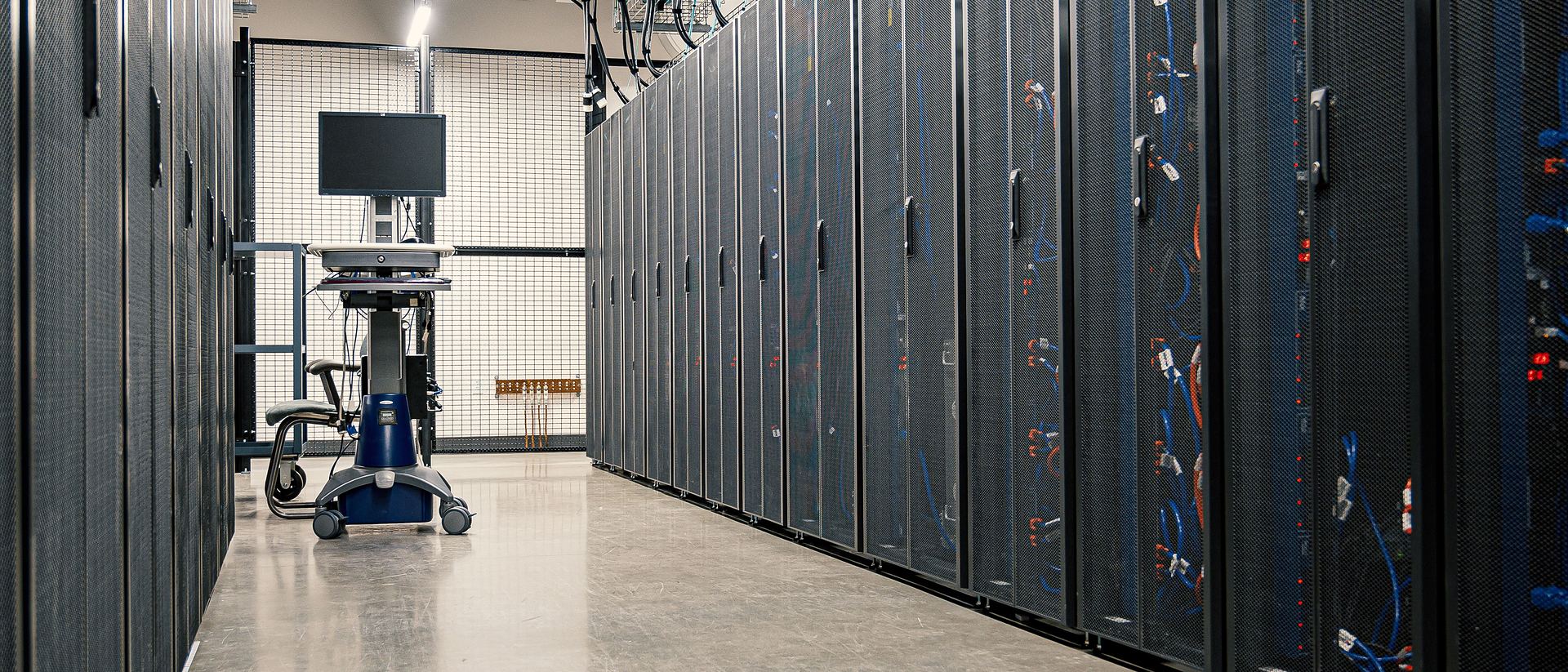 Data-centre aisle with rows of equipment cabinets